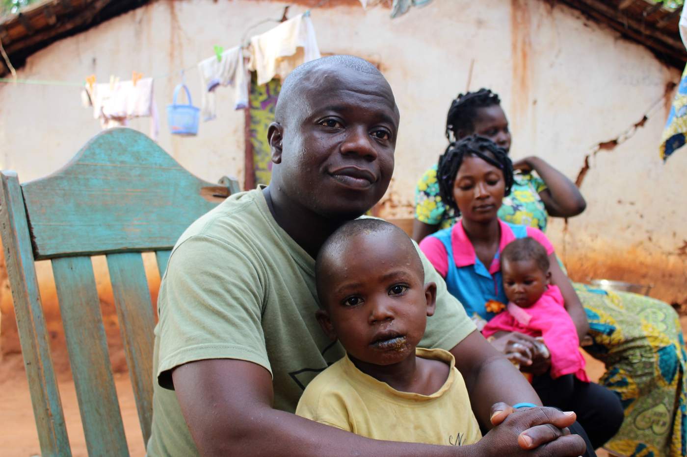 Bruno Yabongo and his family in front of their provisional house in Ngoungbé, just outside of Bangui. Photo: Tijs Magagi Hoornaert\/UN Migration Agency (IOM) 2017
