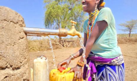 Elena, mother of three, fetches water through an IOM established water resource in Ethiopia. Photo: IOM 2024/Misgana Kurunde